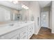 Bathroom with dual sinks, bright lighting, and hardwood flooring leading to another room at 5375 Citadel Dr, Noblesville, IN 46062
