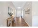 Bright foyer with wood floors features a console table and a view of the front door and hallway at 5375 Citadel Dr, Noblesville, IN 46062
