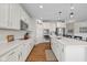 Modern white kitchen featuring stainless steel appliances, quartz countertops, and pendant lighting at 5375 Citadel Dr, Noblesville, IN 46062