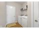 Well-lit laundry room boasts a full-size washer and dryer, plus shelving for storage at 5375 Citadel Dr, Noblesville, IN 46062
