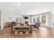 Spacious living room with hardwood floors, a fireplace, and large windows for natural light at 5375 Citadel Dr, Noblesville, IN 46062
