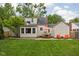 Manicured backyard with a patio, dining table with umbrella, and comfortable seating at 5439 Indianola Ave, Indianapolis, IN 46220