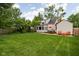 Spacious backyard features lush lawn, mature trees and patio area at 5439 Indianola Ave, Indianapolis, IN 46220