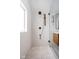 Bathroom with walk-in shower, window, and hexagon tile floor at 5439 Indianola Ave, Indianapolis, IN 46220