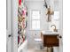 Charming bathroom featuring a stylish vanity, a floral shower curtain, and classic white tile at 5439 Indianola Ave, Indianapolis, IN 46220