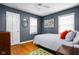 Bedroom featuring wood floors, a ceiling fan, and neutral paint, creating a relaxing atmosphere at 5439 Indianola Ave, Indianapolis, IN 46220