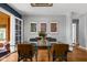 Sunlit dining room with seating for six, a glass table, and a stylish mid-century modern aesthetic at 5439 Indianola Ave, Indianapolis, IN 46220