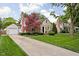 Charming stone and vinyl home featuring a large driveway and a detached garage at 5439 Indianola Ave, Indianapolis, IN 46220