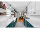 Bright kitchen with white subway tile, open shelving, and teal lower cabinets at 5439 Indianola Ave, Indianapolis, IN 46220