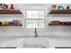 Farmhouse sink with open shelving, bright window and modern fixtures at 5439 Indianola Ave, Indianapolis, IN 46220