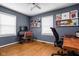 A home office with wood floors, a modern desk setup, and plenty of natural light, perfect for working remotely at 5439 Indianola Ave, Indianapolis, IN 46220