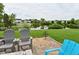 Backyard fire pit area with views of a pond and surrounding neighborhood at 5507 Wakefield Rd, Greenwood, IN 46142