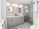Modern bathroom with double vanity, framed mirrors, and a glass-enclosed shower at 5507 Wakefield Rd, Greenwood, IN 46142