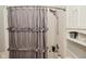 Shower with gray ruffle curtain and brushed nickel fixtures at 5507 Wakefield Rd, Greenwood, IN 46142