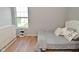 A bedroom with a light gray bed, white dresser, and ample natural light offers a comfortable and serene retreat at 5507 Wakefield Rd, Greenwood, IN 46142