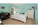 Whimsical bedroom with vibrant turquoise walls, a plush bed, and decorative shelving at 5507 Wakefield Rd, Greenwood, IN 46142