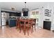 A dining area features a wooden table and chairs next to the kitchen with stainless steel appliances and dark blue cabinets at 5507 Wakefield Rd, Greenwood, IN 46142