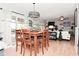 The dining area flows to a living room space, showcasing the open floorplan and plenty of natural light and neutral paint at 5507 Wakefield Rd, Greenwood, IN 46142