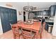A dining table is prominently displayed in a kitchen with dark blue cabinets, offering a cozy space for meals and gatherings at 5507 Wakefield Rd, Greenwood, IN 46142