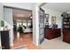 Warm entryway showcasing an office with a view into the spacious living room and hardwood floors at 5507 Wakefield Rd, Greenwood, IN 46142