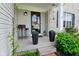 Inviting front porch with decorative plants, stylish decor, and a charming entrance door at 5507 Wakefield Rd, Greenwood, IN 46142