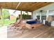 Backyard deck featuring a hot tub, seating, outdoor decor, and manicured landscaping for outdoor enjoyment at 5507 Wakefield Rd, Greenwood, IN 46142