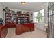 Inviting home office featuring ample shelving, a large desk, and a window with natural light at 5507 Wakefield Rd, Greenwood, IN 46142