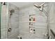 Close-up of a modern shower with dual shower heads, mosaic tile niche, and stone bench at 5507 Wakefield Rd, Greenwood, IN 46142