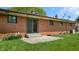 Brick home exterior with sliding glass door and a well-maintained lawn and patio at 5683 Steven Dr, Greenwood, IN 46142