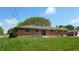 Brick house with well-kept lawn, patio, and garden, perfect for outdoor enjoyment at 5683 Steven Dr, Greenwood, IN 46142