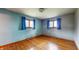Bright bedroom featuring hardwood floors, two windows, and blue walls at 5683 Steven Dr, Greenwood, IN 46142
