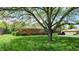 Charming brick ranch home featuring a well-manicured lawn and mature shade trees in a suburban neighborhood at 5683 Steven Dr, Greenwood, IN 46142