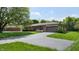 Charming home with a paved driveway, attached garage, and beautifully landscaped yard at 5683 Steven Dr, Greenwood, IN 46142