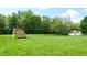 Large backyard featuring mature trees and two sheds, perfect for outdoor storage and activities at 5683 Steven Dr, Greenwood, IN 46142