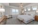 Serene bedroom with tray ceiling, chandelier, large window and sitting area with elegant furnishings at 5784 Summertree Pl, Whitestown, IN 46052