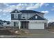 New two-story home with blue and gray siding, a two car garage, and fresh concrete driveway at 5784 Summertree Pl, Whitestown, IN 46052