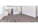 Bright kitchen features stainless appliances, white cabinets and island, and wood grain floors at 5784 Summertree Pl, Whitestown, IN 46052