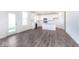 Bright kitchen features stainless appliances, white cabinets and island, and wood grain floors at 5784 Summertree Pl, Whitestown, IN 46052