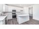 Bright kitchen features stainless appliances, white cabinets and island, and wood grain floors at 5784 Summertree Pl, Whitestown, IN 46052