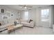 Bright living room features neutral décor, ceiling fan, large windows, and comfortable sectional sofa at 5784 Summertree Pl, Whitestown, IN 46052