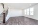 Bright living room features natural light from large windows and a stairway with wood grain floors at 5784 Summertree Pl, Whitestown, IN 46052