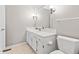 Bright bathroom with a white single sink vanity with storage, a large mirror and toilet at 582 Conner Creek Dr, Fishers, IN 46038