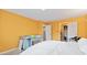 Bedroom featuring yellow wall, white bedding, a baby crib, and open doors to a closet and bathroom at 582 Conner Creek Dr, Fishers, IN 46038