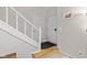 Entryway featuring the staircase with white banisters, a coat closet and a front door at 582 Conner Creek Dr, Fishers, IN 46038