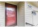 Close up of the front door with address number, exterior light fixture, and a storm door at 582 Conner Creek Dr, Fishers, IN 46038