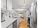 Bright kitchen with stainless appliances and modern sink that opens to a dining area with view of fireplace at 582 Conner Creek Dr, Fishers, IN 46038