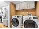 Convenient laundry room with modern washer and dryer units, plus storage cabinets at 582 Conner Creek Dr, Fishers, IN 46038