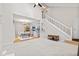 Open concept living area featuring high ceilings, a staircase, with a dining area and kitchen in the background at 582 Conner Creek Dr, Fishers, IN 46038