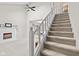 Inviting staircase leading to the upper level with neutral carpeting and natural light at 582 Conner Creek Dr, Fishers, IN 46038