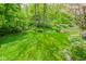 A lush green backyard with mature trees and a well-maintained lawn offers a serene outdoor space at 5851 Beisinger Pl, Indianapolis, IN 46237